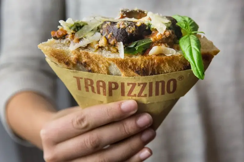 Trapizzino pizza pocket filled with Italian meatballs in Rome